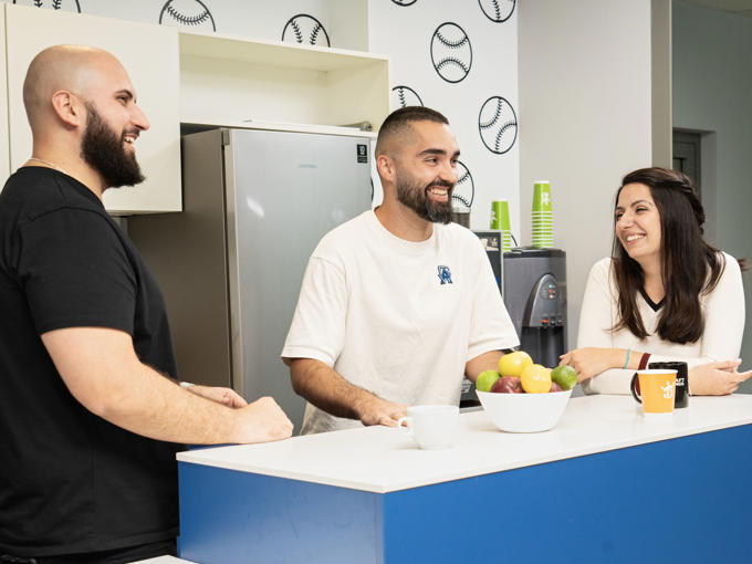 a group of people standing around a counter