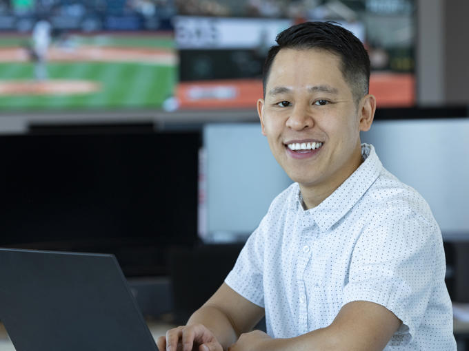 a man sitting at a table with a laptop