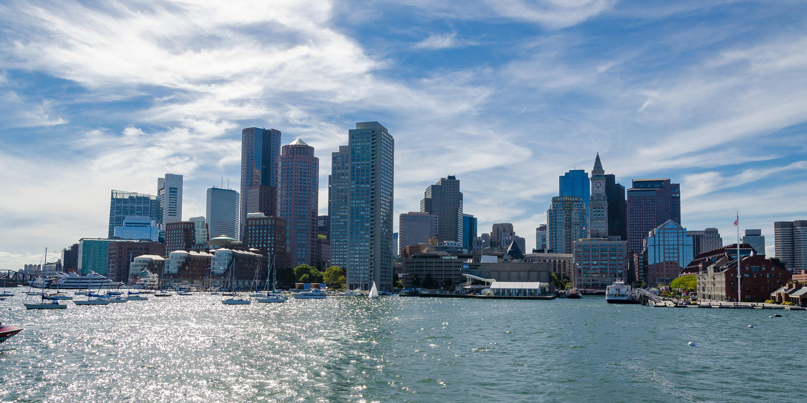 a city skyline with boats on water