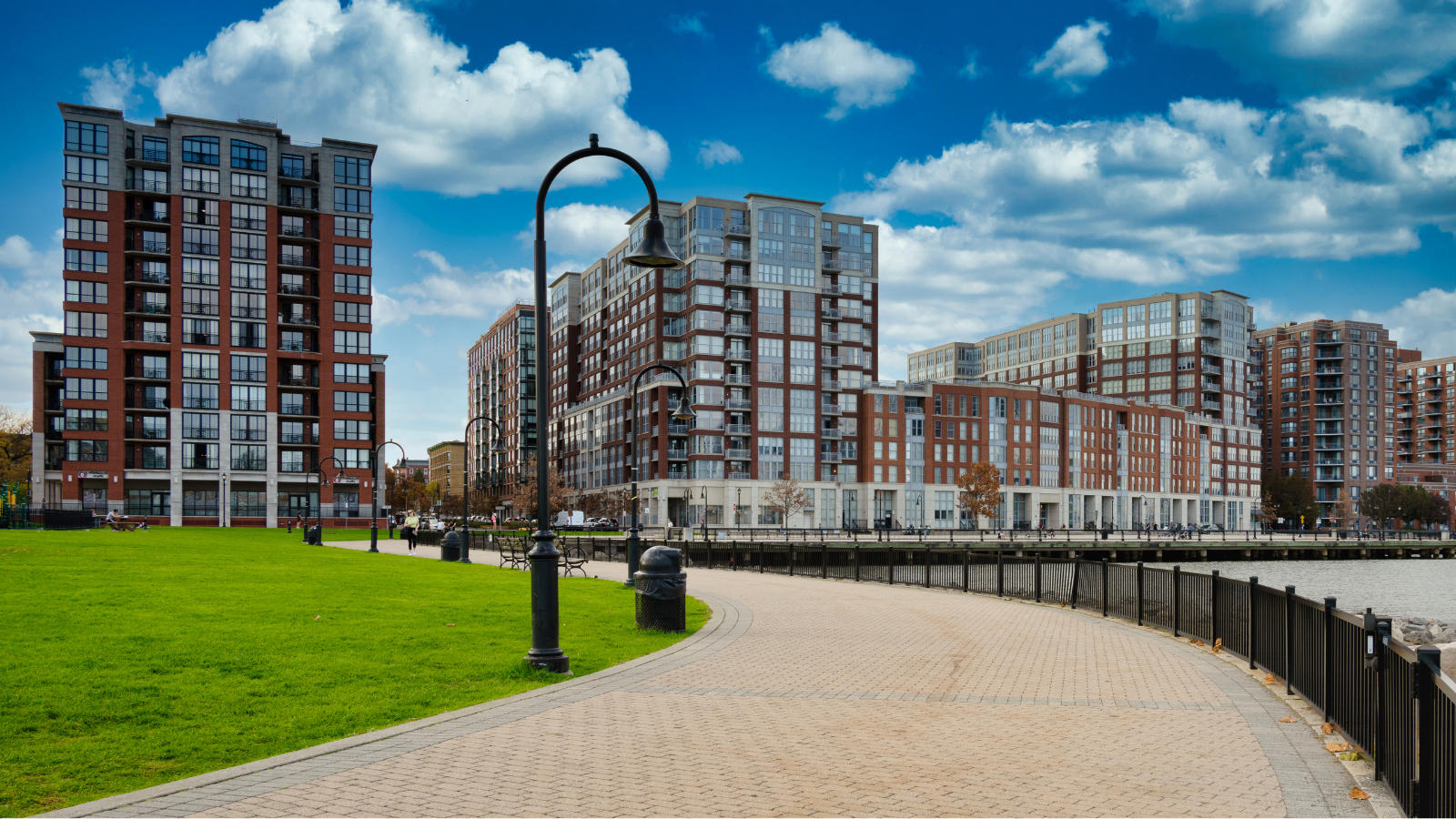 a walkway with a walkway and buildings in the background
