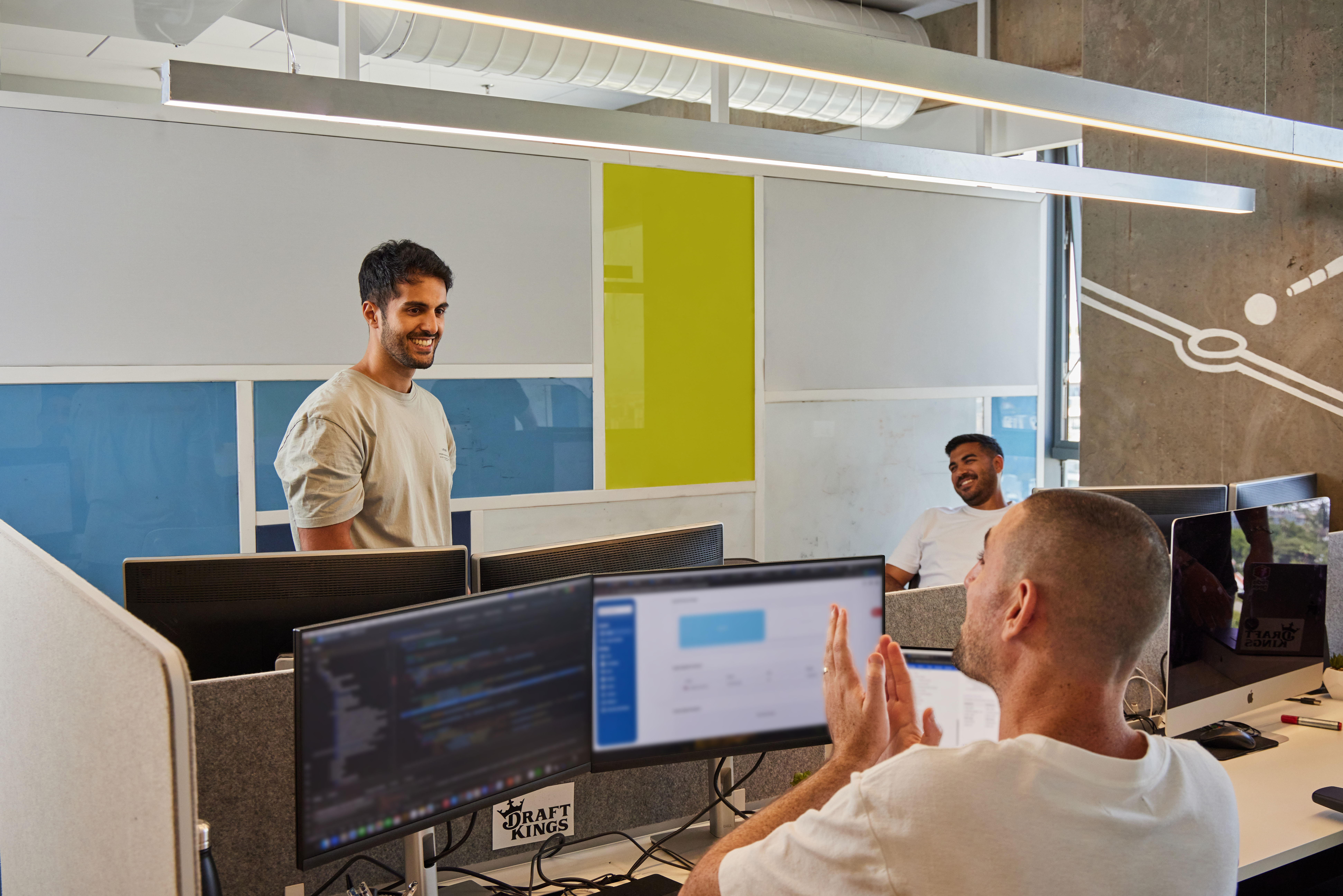 a group of men in a room with computers
