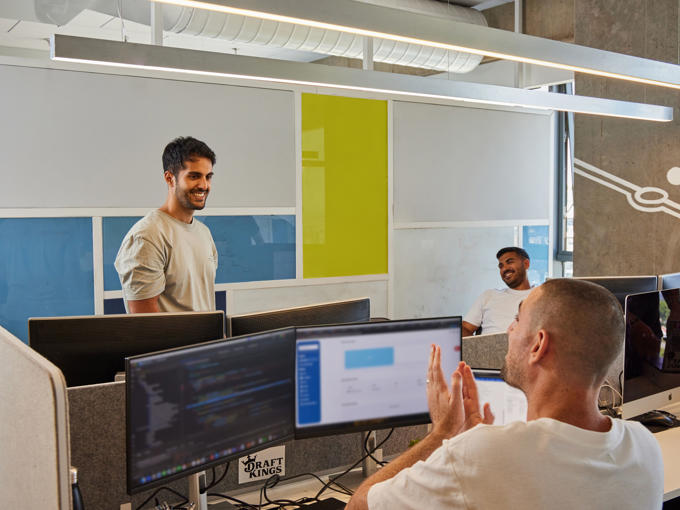 a group of men in a room with computers