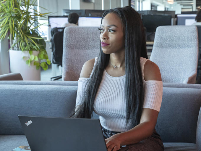 a woman sitting in a chair with a laptop
