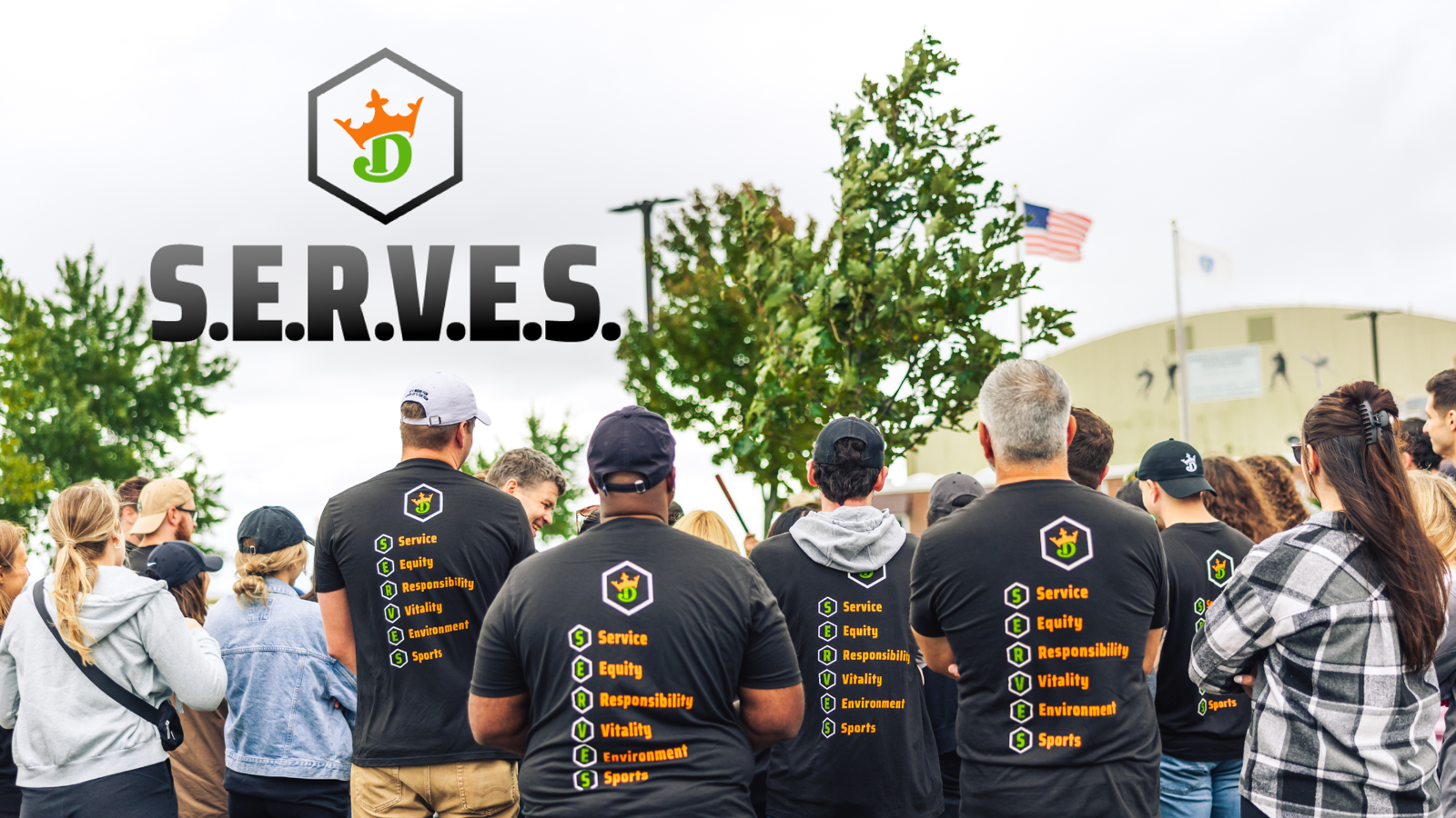 a group of people wearing black shirts with text on them