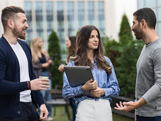 a group of people talking outside