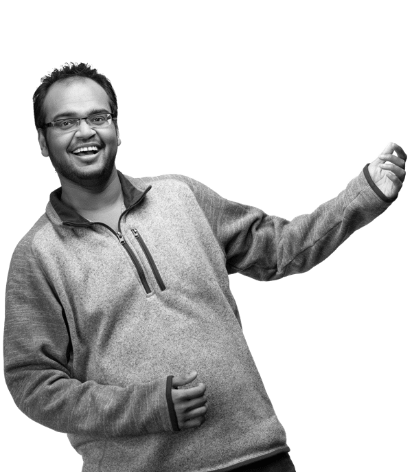 a man wearing glasses and a sweater
