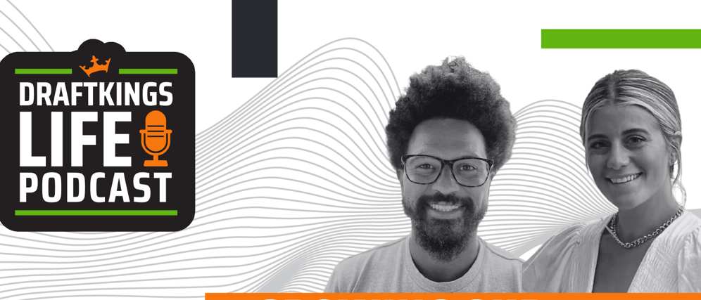 a man with curly hair and glasses smiling