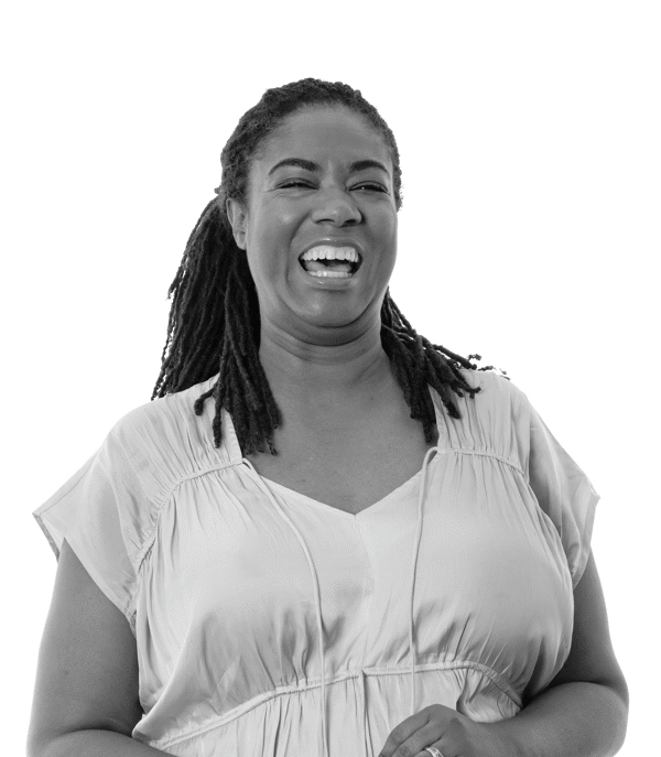 a woman laughing with her hands together