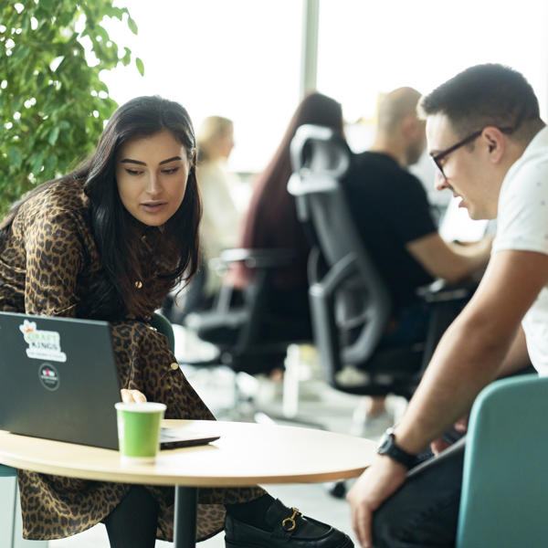 a man and woman looking at a laptop