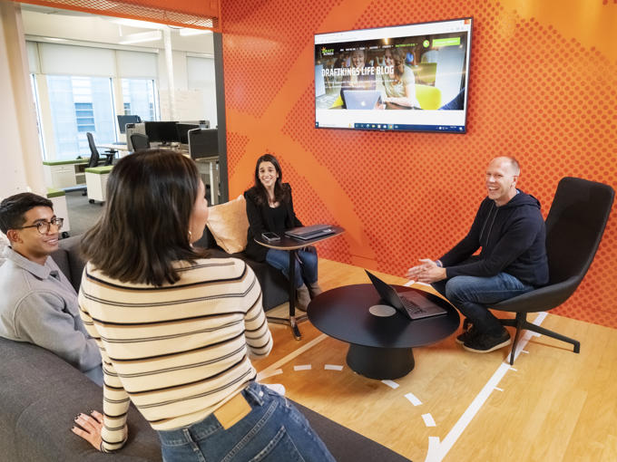 a group of people sitting in chairs and talking